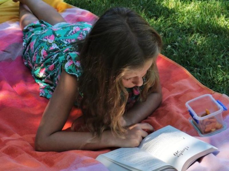 Girl on towel reading